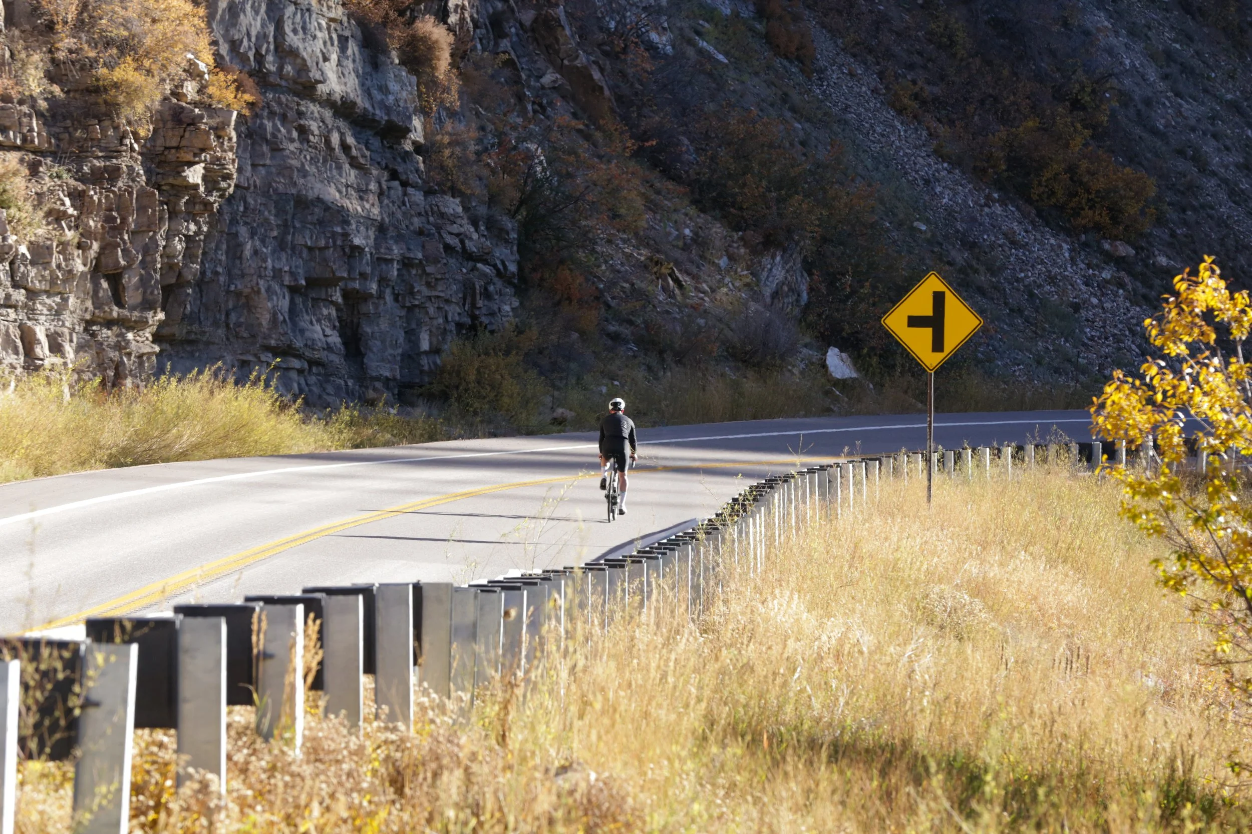 Cyclist on a Colorado road at sunset