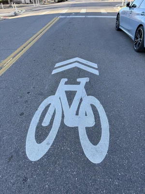 Painted sharrow shared-lane marking on a city street